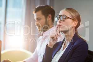 Thoughtful businesswoman with hand on chin