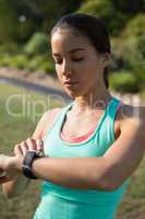 Woman adjusting a time on wristwatch