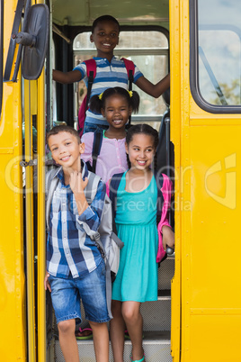 Portrait of school kids looking from bus