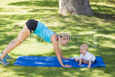 Woman exercising with her baby