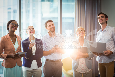 Group of business people holding mobile phone, digital tablet an