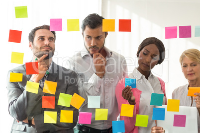 Business people looking at adhesive notes