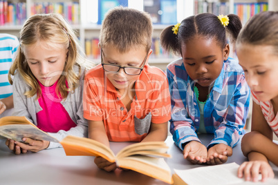 Kids reading a book in library