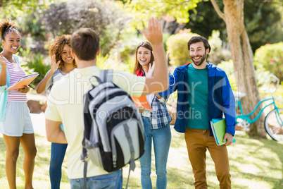 Group of friends waving each other