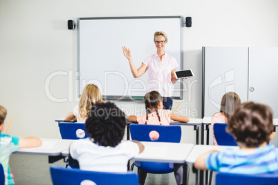 Teacher teaching kids on digital tablet