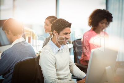 Man working on computer with coworker