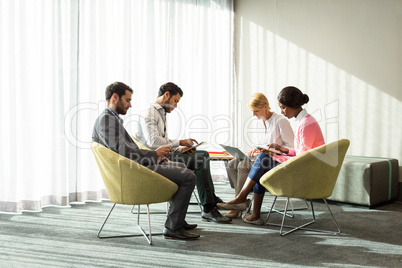 Business people using mobile phone, digital tablet and laptop