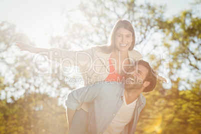 Man giving woman piggyback ride