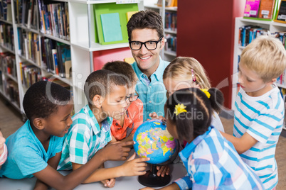 Teacher and kids discussing globe