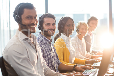 Team of colleagues working at their desk with headset