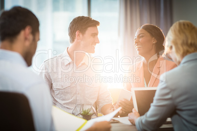 Group of business people interacting at desk