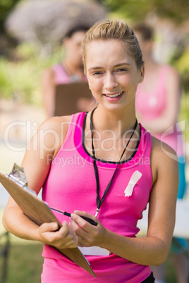 Female volunteer writing in clipboar