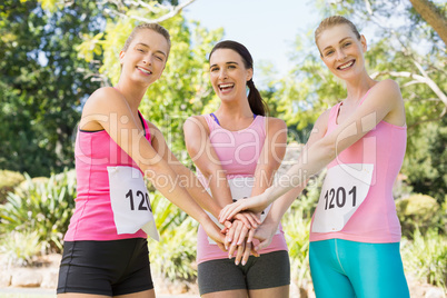 Young athlete women forming hands stack