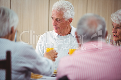 Senior people having an orange juice drink