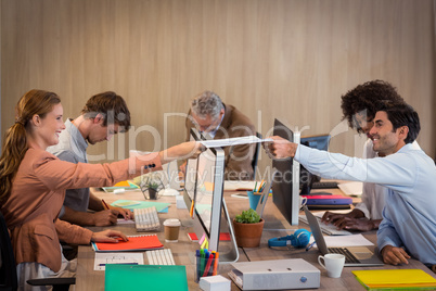 Businessman passing a file to his colleague