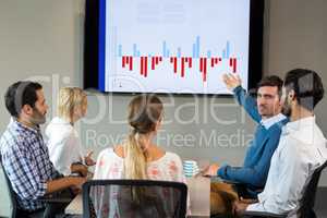 Business people discussing over graph during a meeting