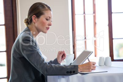 Woman using tablet and notebook