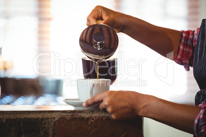 Waitress preparing a coffee