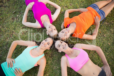 Beautiful young women lying on grass