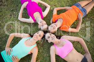 Beautiful young women lying on grass