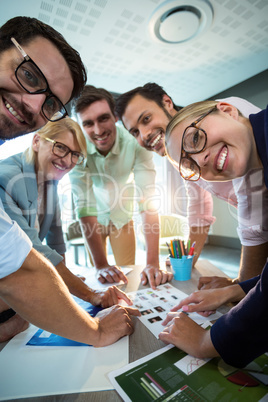 Business people discussing over photograph during a meeting