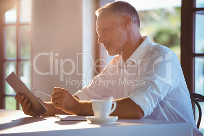 Man using tablet and notebook Man using tablet and notebook