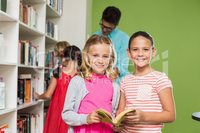 Kids reading book in library