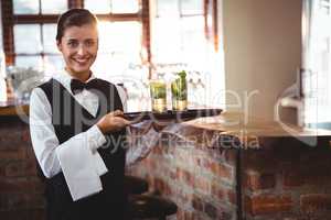 Female bartender holding a serving tray with two cocktail glass