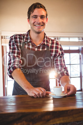 Waiter holding a cup of coffee Waiter holding a cup of coffee