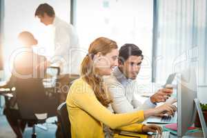 Executives working on laptop and computer