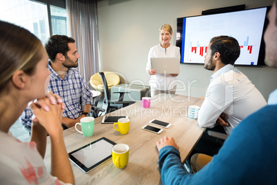 Business people discussing over graph during a meeting