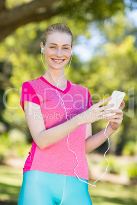 Beautiful woman listening music on mobile phone