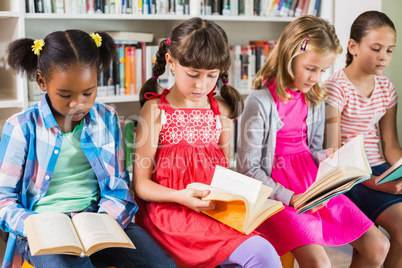 Kids reading a book in library