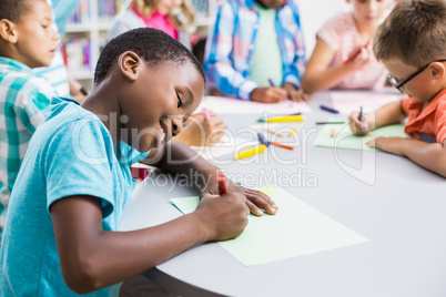 Schoolboy drawing in paper