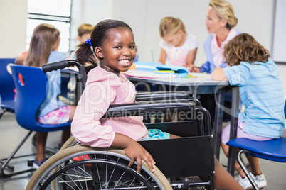 Disabled schoolgirl smiling in classroom