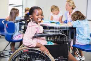 Disabled schoolgirl smiling in classroom