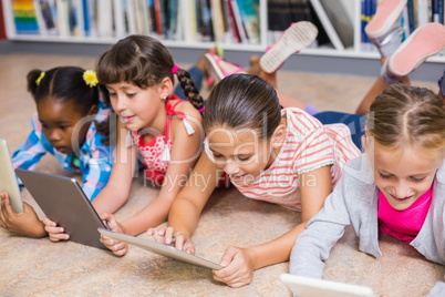 Kids using digital tablet in library