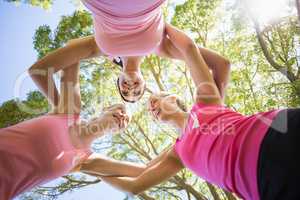 Portrait of young volunteer women forming huddles