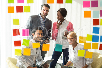 Business people looking at adhesive notes