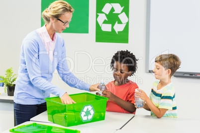 Teacher and kids discussing about recycle
