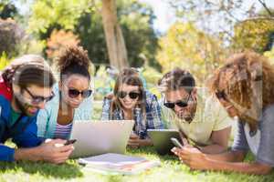 Group of friends using laptop, mobile phone and digital tablet