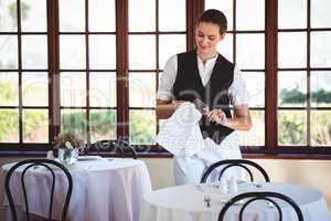 Waitress cleaning wineglass