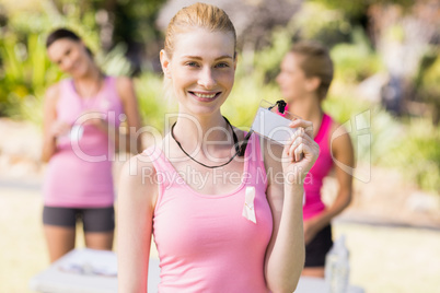 Female volunteer showing her identity card