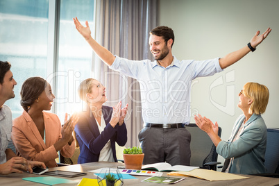 Coworkers applauding a colleague after presentation