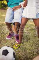 Zoom on family playing football