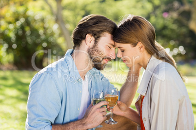 Portrait of couple holding glass of wine