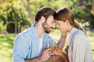 Portrait of couple holding glass of wine