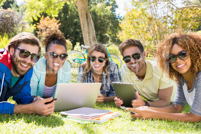 Group of friends using laptop, mobile phone and digital tablet