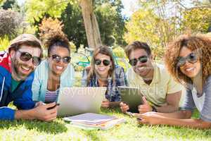 Group of friends using laptop, mobile phone and digital tablet