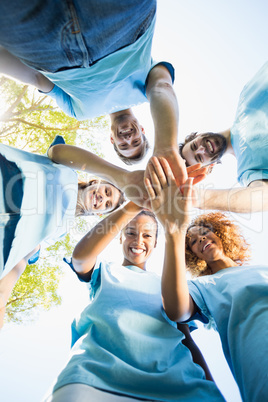 Portrait of volunteer group forming huddles